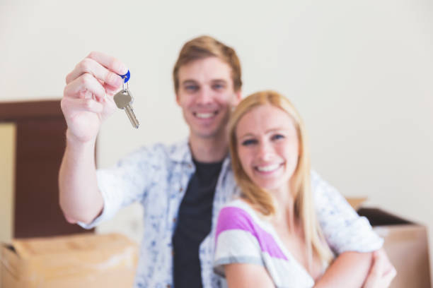 istock Married couple showing off their house keys 831024508