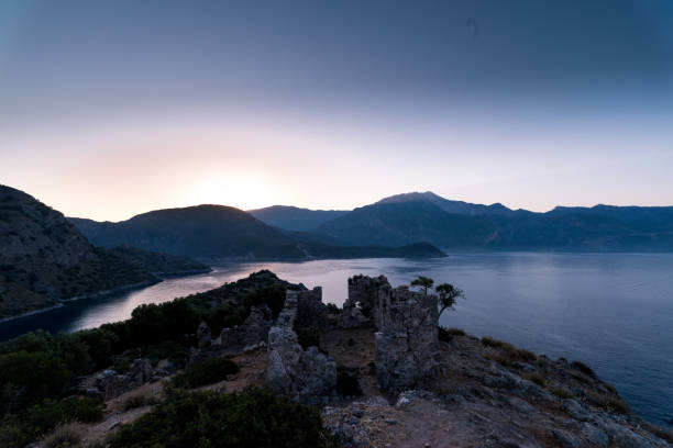 istock Sunrise over sea and mountains. Rocks and water senery 831032198