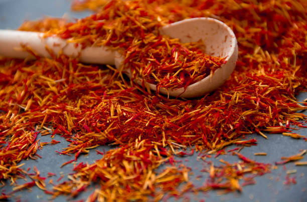 istock Saffron in a spoon on a dark background, selective focus, macro shot, shallow depth of field 831035216