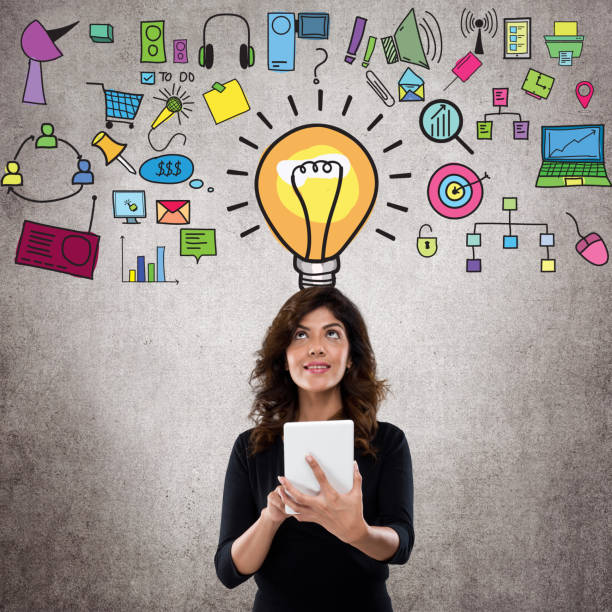 istock Businesswoman using digital tablet in front of icons 831038362