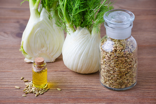 fennel essential oil, bulb and seeds, selective focus