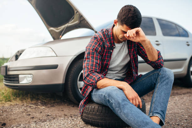 istock Tired man sitting on tire, broken car 831046420
