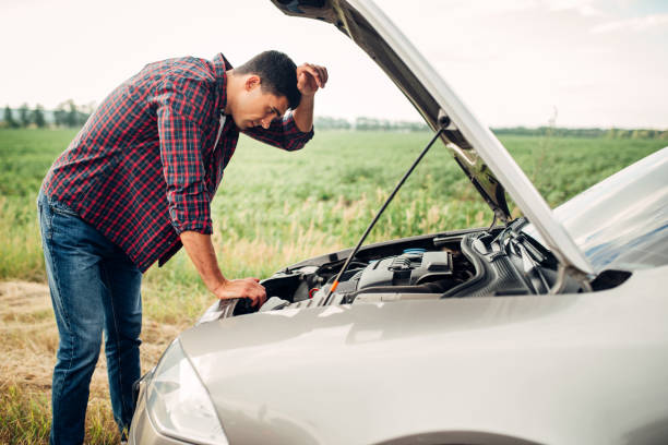 istock Tired man tries to repair a broken car 831046476