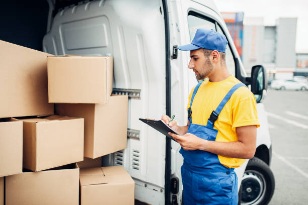istock Cargo delivery, male courier with box in hand 831049684
