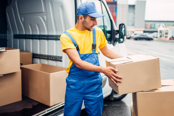 Cargo delivery service, male courier unload truck stock photo