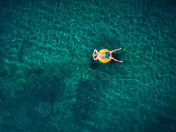 istock Young man relaxing in the ocean 831049994