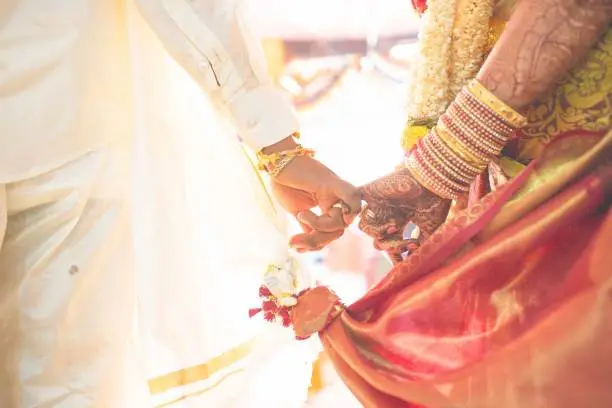 hindu wedding bride and groom celebrating wedding event with flower decorations