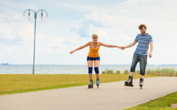 istock Young couple on roller skates riding outdoors 831050346