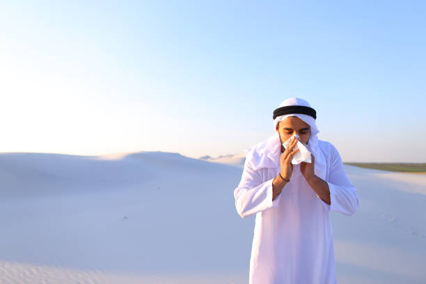 istock Arabian guy feels unpleasant sensations with cold, standing in m 831053256
