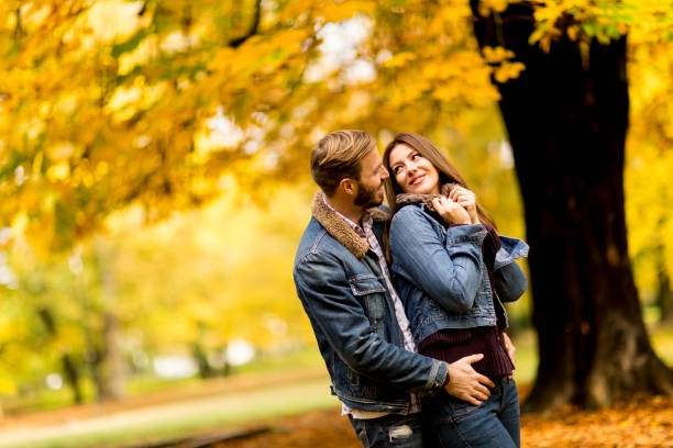 istock Young loving couple in the autumn park 831053668