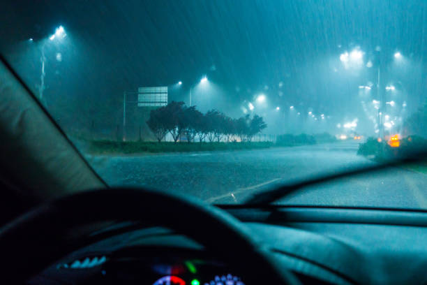 istock Driving a car in rain night 831057338