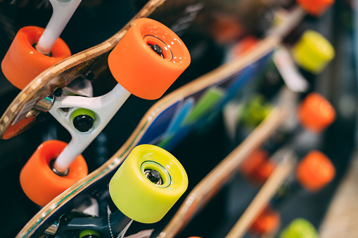 Close Detail View Of Colorful Skateboards Displayed At The Rack On Sale In Shopping Store.