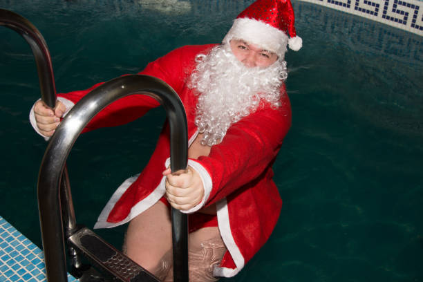 istock Funny Santa in the pool. 831074850