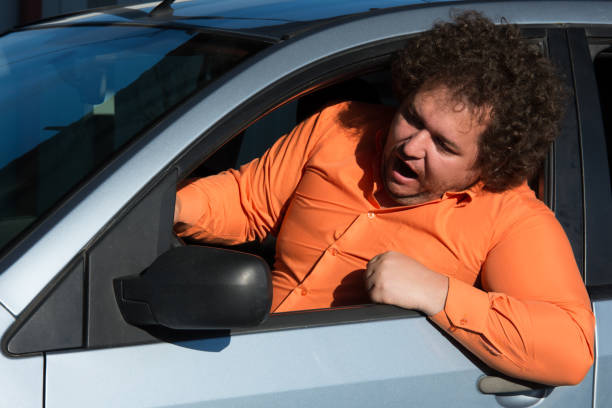 Funny man in the car. Street. Heat. A fat guy in a blue car. emergency room human head physical injury drunk stock pictures, royalty-free photos & images