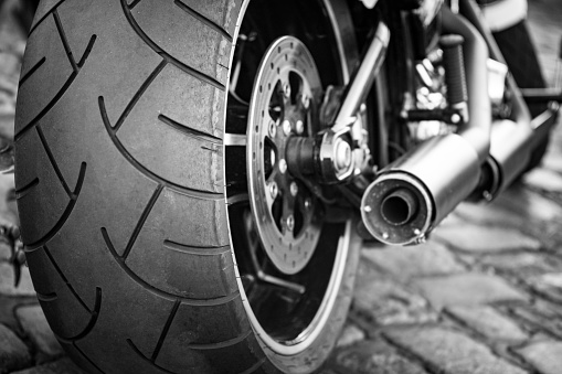 Motorcycle exhaust and rear tire profile close up