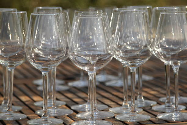 istock Wine glasses on wooden table 831085122