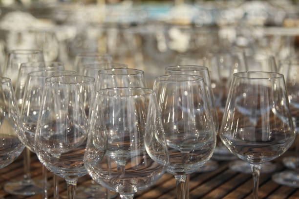 istock Wine glasses on wooden table 831085134