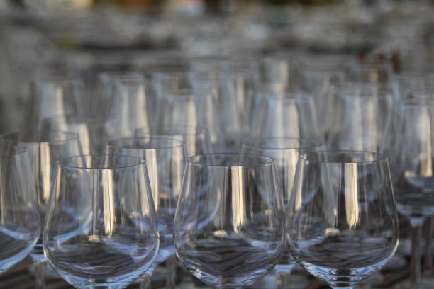 istock Wine glasses on wooden table 831085164