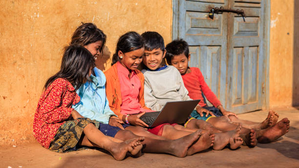 istock Happy Cambodian children using laptop on a schoolyard, Cambodia 831089552