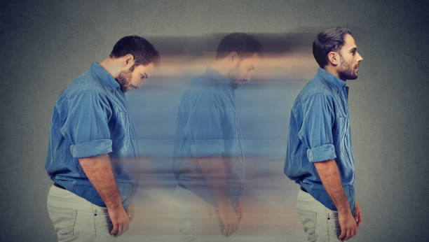 Side profile of a young chubby man transformation into a slim person stock photo