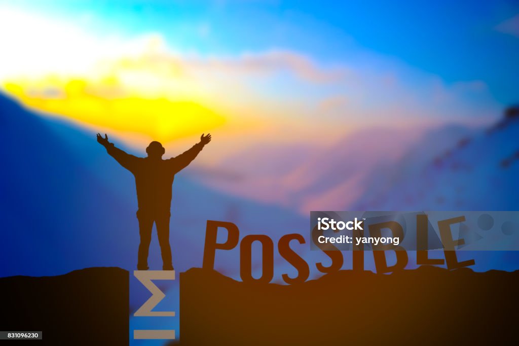 Man standing over impossible or possible over cliff on sunset background Man standing over impossible or possible over cliff on sunset background, Business concept idea Mountain Stock Photo