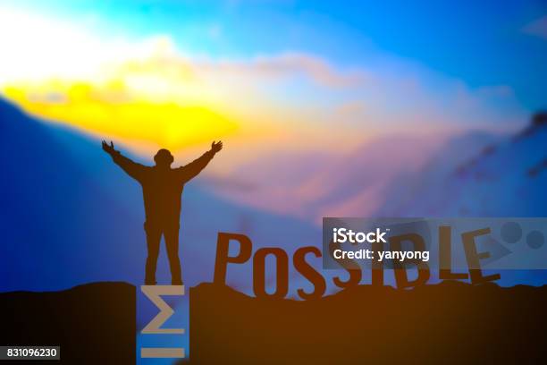 Man Standing Over Impossible Or Possible Over Cliff On Sunset Background Stock Photo - Download Image Now