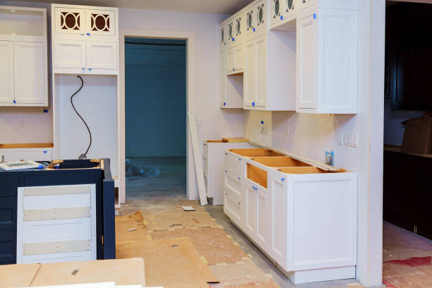 istock Custom kitchen cabinets in various stages of installation base for island in center 831096544