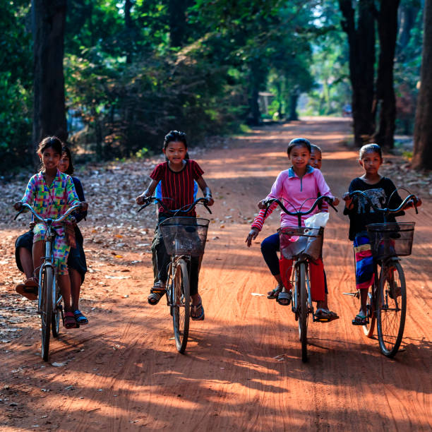 istock Happy Cambodian children riding bicycles, Cambodia 831096592