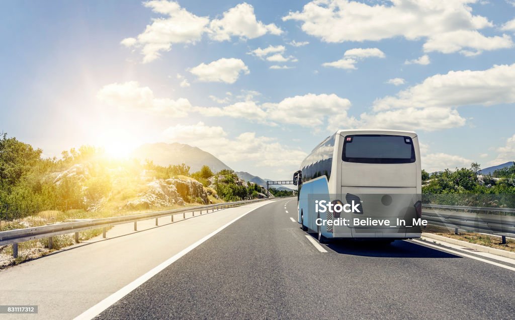 Bus rushes along the asphalt high-speed highway Tourist bus rushes along the asphalt high-speed highway. Bus Stock Photo