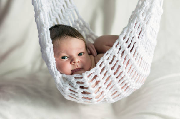 Two weeks old baby boy  is lying in the hammock