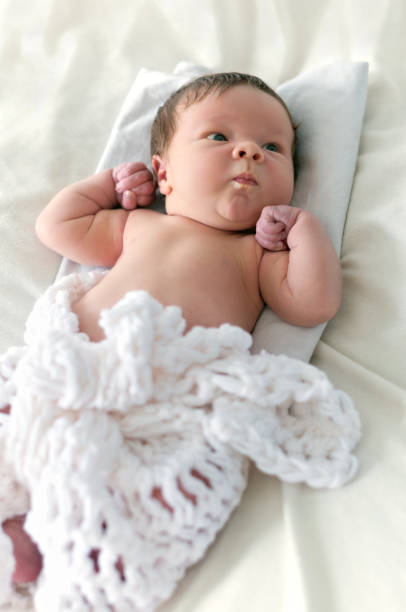 Two weeks old baby boy  wrapped in the blanket knitted