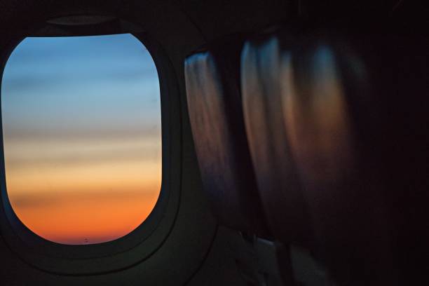 istock colorful sunrise in airplane window 831128624