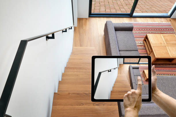 Mobile device with man hands taking picture Mobile device with man hands taking picture on Hardwood stairs and ramp in modern renovated living room duplex stock pictures, royalty-free photos & images