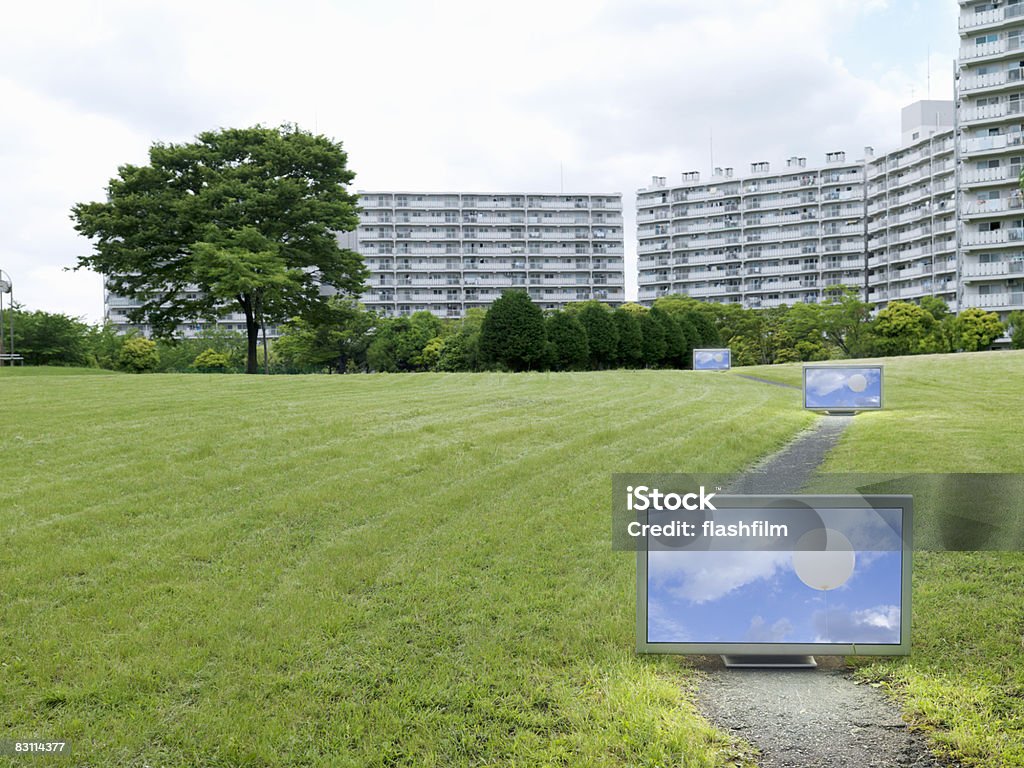 Flat TV placed in front of urban apartments Digital Composite Apartment Stock Photo