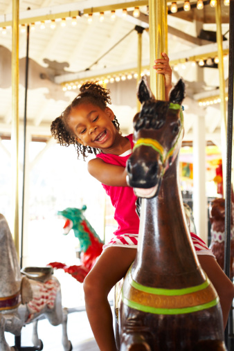 Old style carousel with white horses