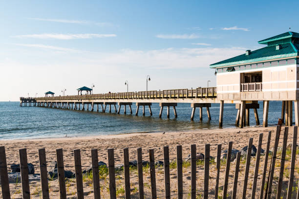 Buckroe Beach Fishing Pier in Hampton, Virginia Hampton, Virginia - July 9, 2017:  The Buckroe Beach fishing pier, located on the site of a former plantation.  The area is now a popular tourist attraction for the beach, fishing and public park. hampton virginia photos stock pictures, royalty-free photos & images