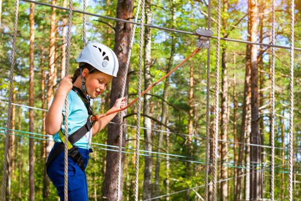 istock Girl on hinged trail in extreme rope Park 831150848