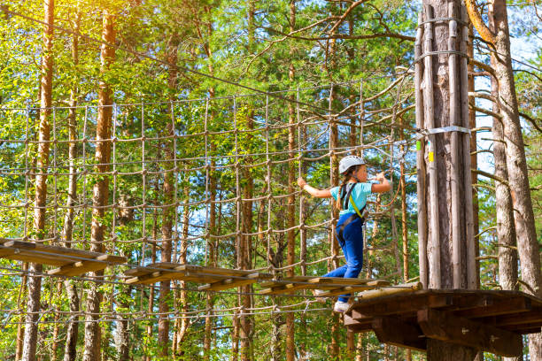 istock Girl on hinged trail in extreme rope Park 831150868