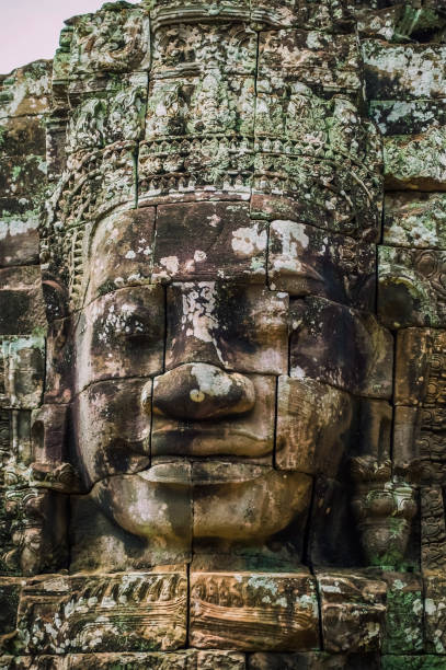 istock Old ancient stone face of Bayon temple at Angor Wat 831155748
