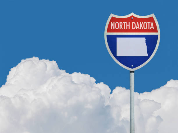 istock Highway sign for Interstate road in North Dakota with map in front of clouds 831156176