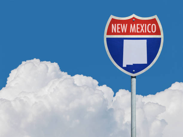 istock Highway sign for Interstate road in New Mexico with map in front of clouds 831159976
