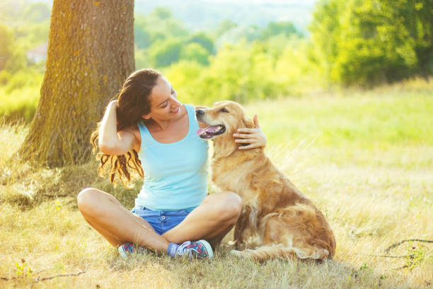 istock Young woman having a fun with her dog 831160670