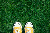 Yellow sneakers in a field