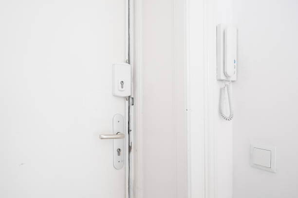 istock door handle , bar lock and interphone system on white apartment door 831163520