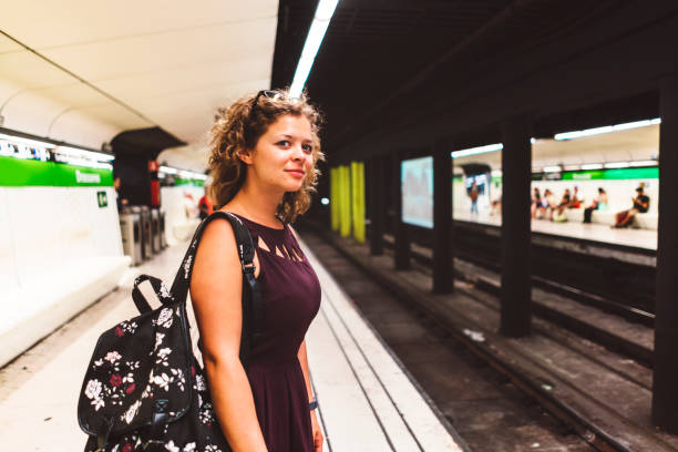 istock Smiling woman waiting at the train station 831164358