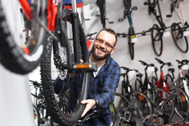 Bicycle shop. Bicycle seller in a bicycle lounge. bicycle shop stock pictures, royalty-free photos & images