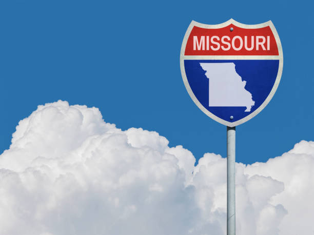 istock Highway sign for Interstate road in Missouri with map in front of clouds 831177238