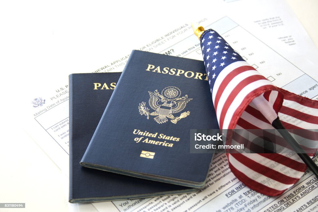 Immigration/travel concept US Passports with flag and renewal forms USA Stock Photo