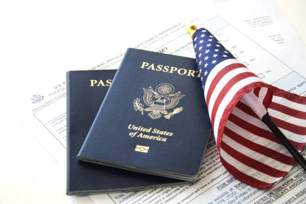 Immigration/travel concept US Passports with flag and renewal forms citizenship photos stock pictures, royalty-free photos & images