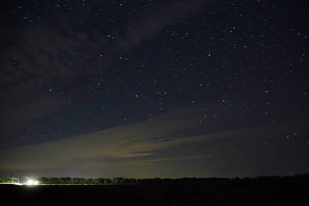 istock Beautiful night sky with stars.  clouds  over field 831184440